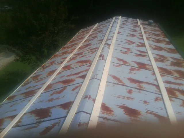 Rusted metal roof panels with new wood purlins before replacement — Storm Damage Roof Repair in Reelsville by Roofing Brothers