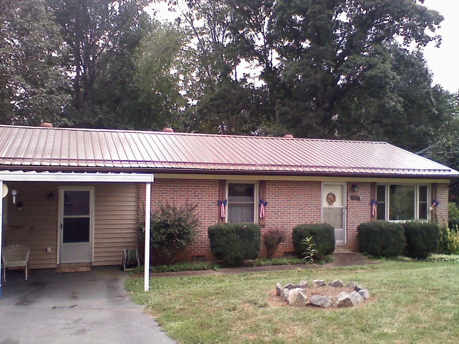 Bronze metal roof and carport on a brick ranch home — Roof Repair work by our crew in Reelsville